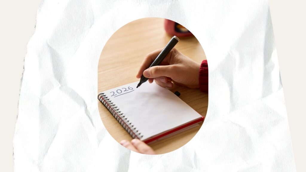 person writing new years resolutions in a notebook