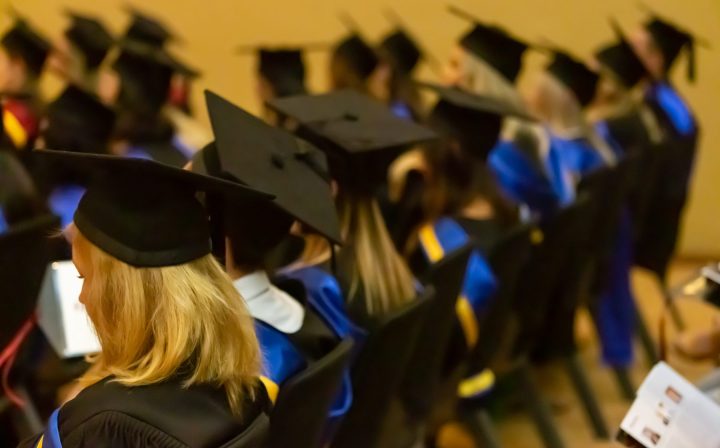 cmi-graduation-hats-students-sitting